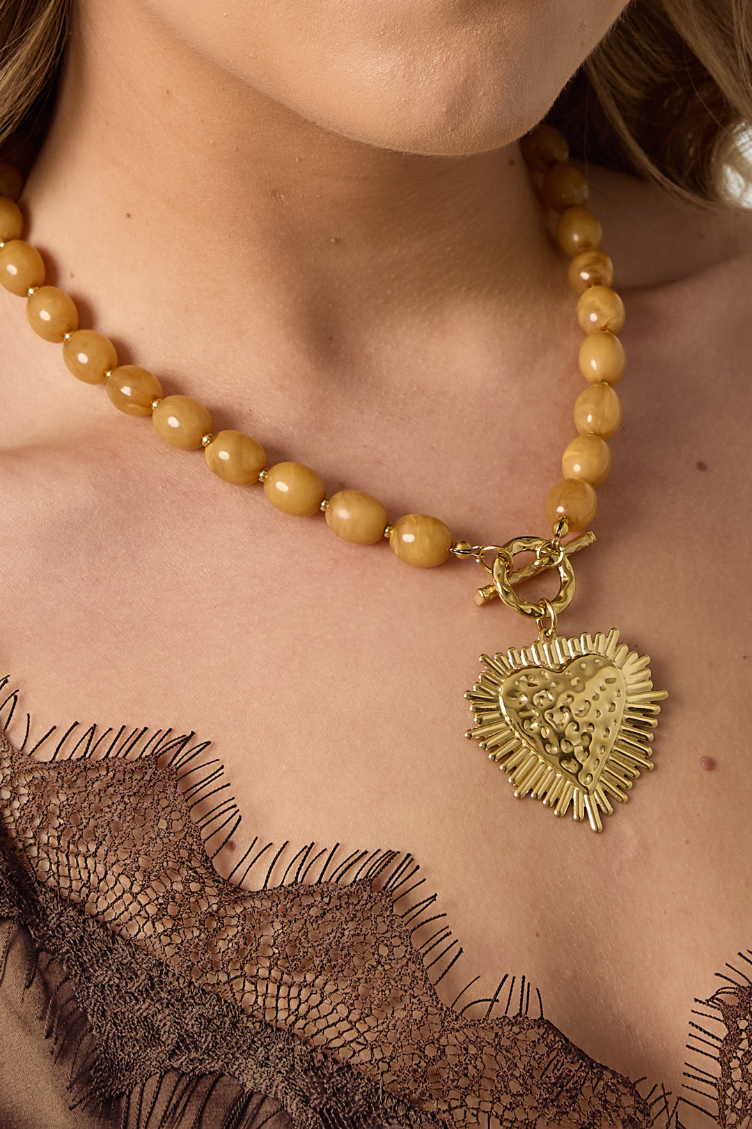 Bead necklace with front closure charm